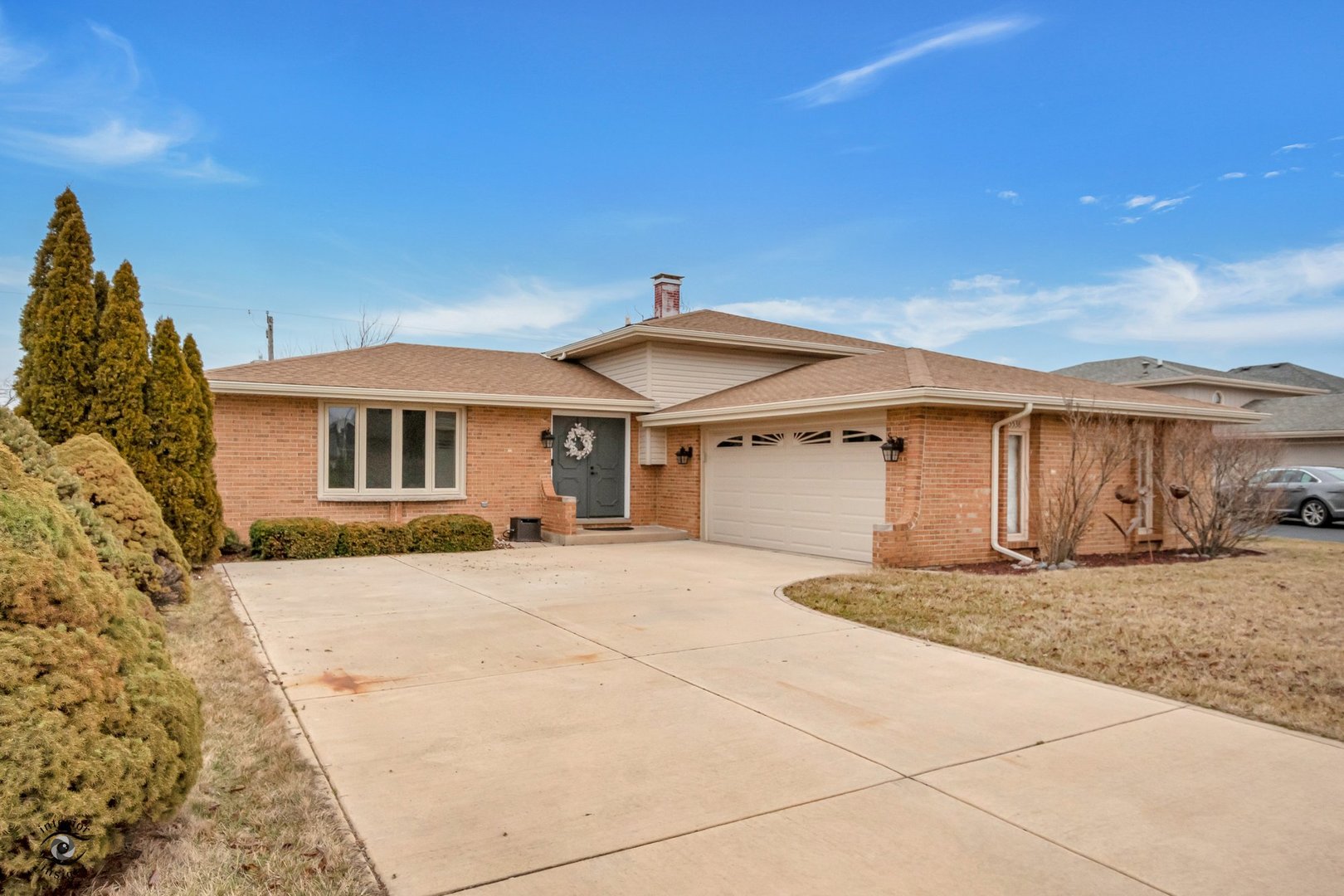 a front view of a house with a yard and garage