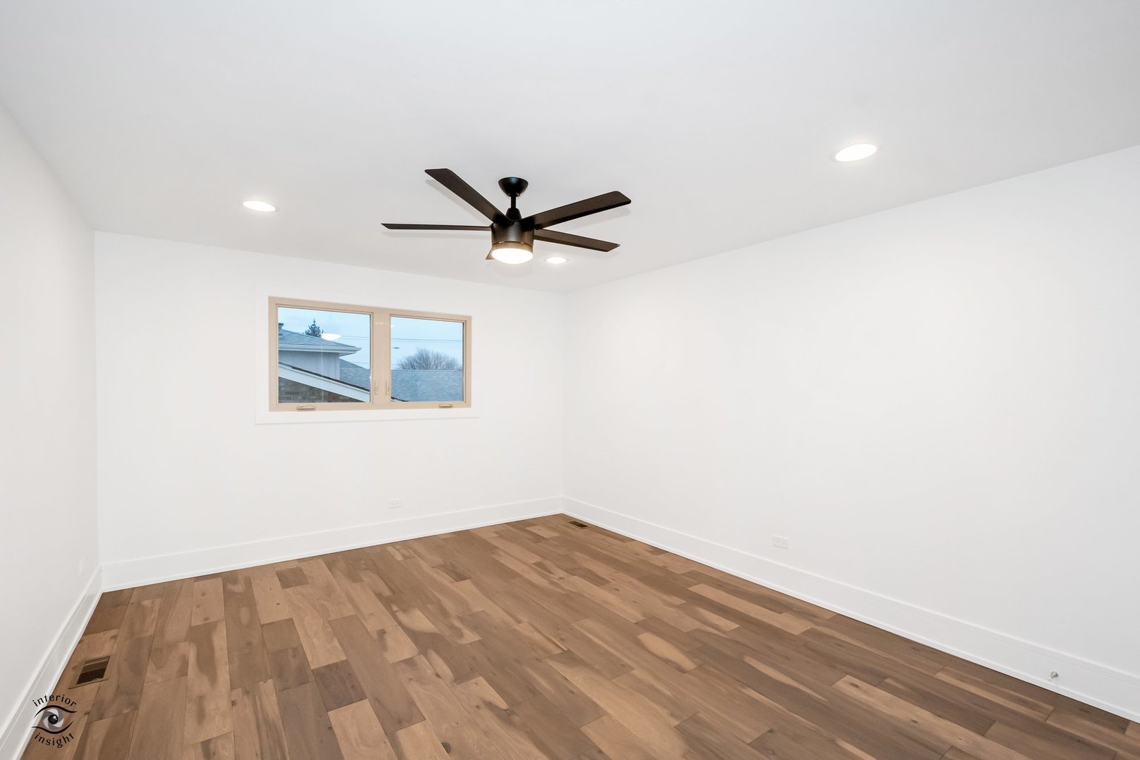 Undisclosed Address Lansing, IL 60438 - Photo 14 of 23 a view of a big room with wooden floor and a ceiling fan