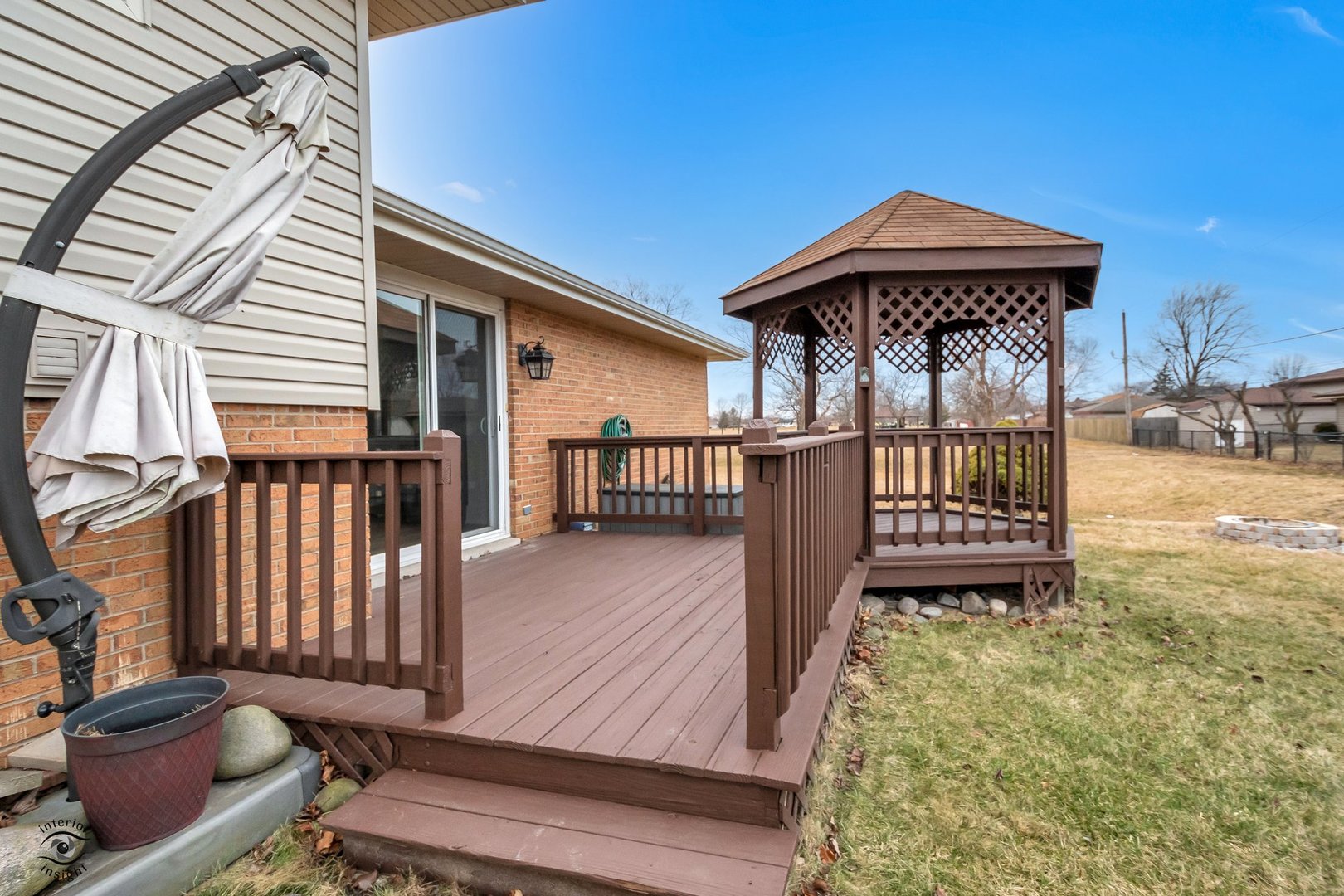 Undisclosed Address Lansing, IL 60438 - Photo 21 of 23 a view of a wooden deck with a barbeque grill and couches