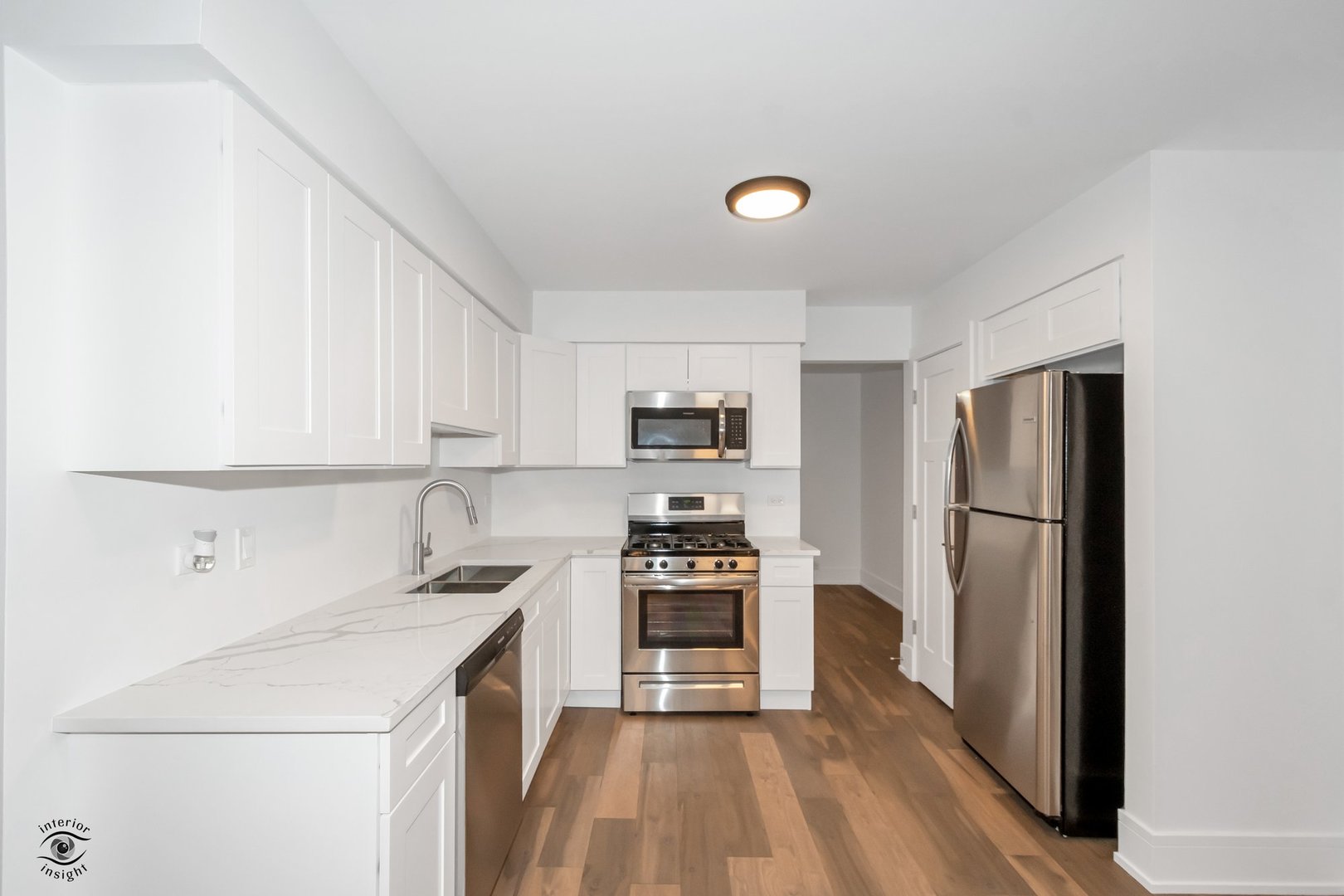 Undisclosed Address Lansing, IL 60438 - Photo 4 of 23 a kitchen with a refrigerator a stove top oven a sink and cabinets