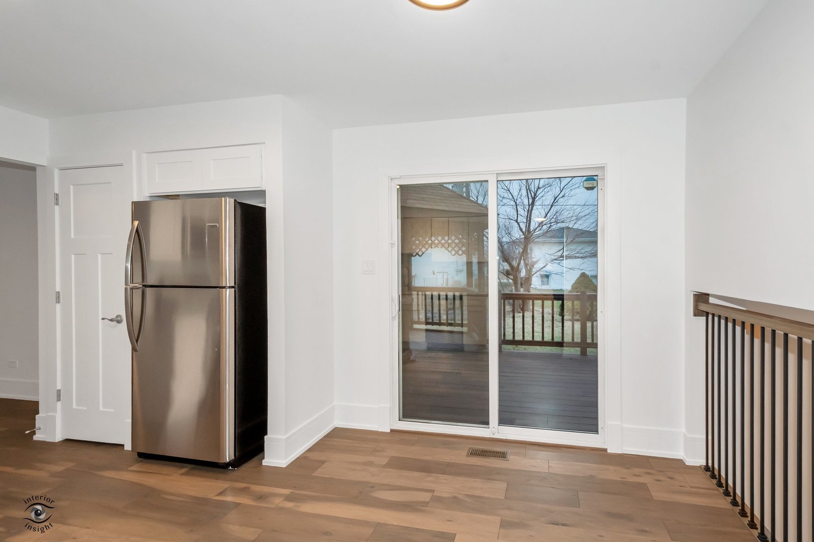 Undisclosed Address Lansing, IL 60438 - Photo 5 of 23 an empty room with wooden floor and a kitchen