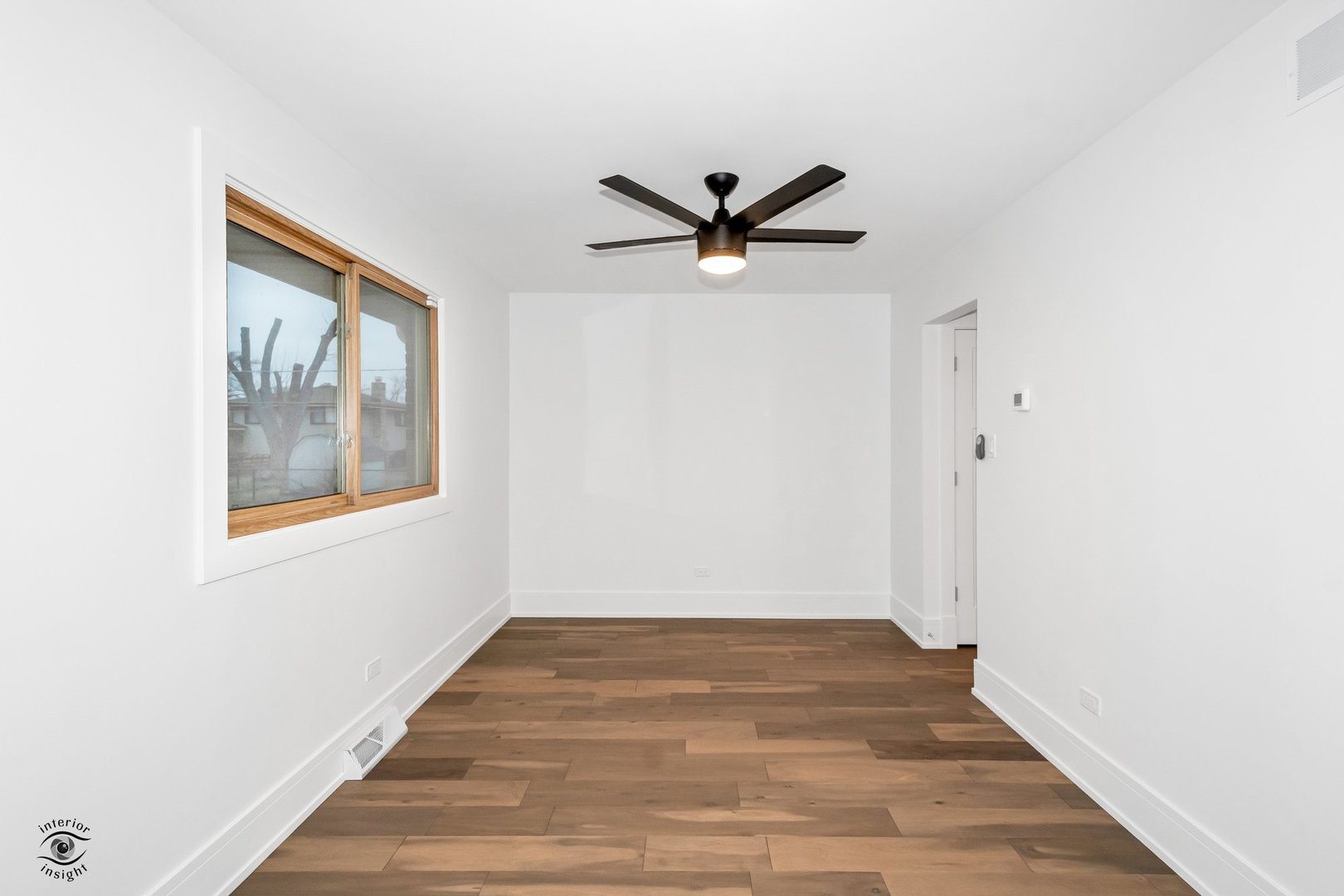 Undisclosed Address Lansing, IL 60438 - Photo 10 of 23 a view of empty room with wooden floor and fan