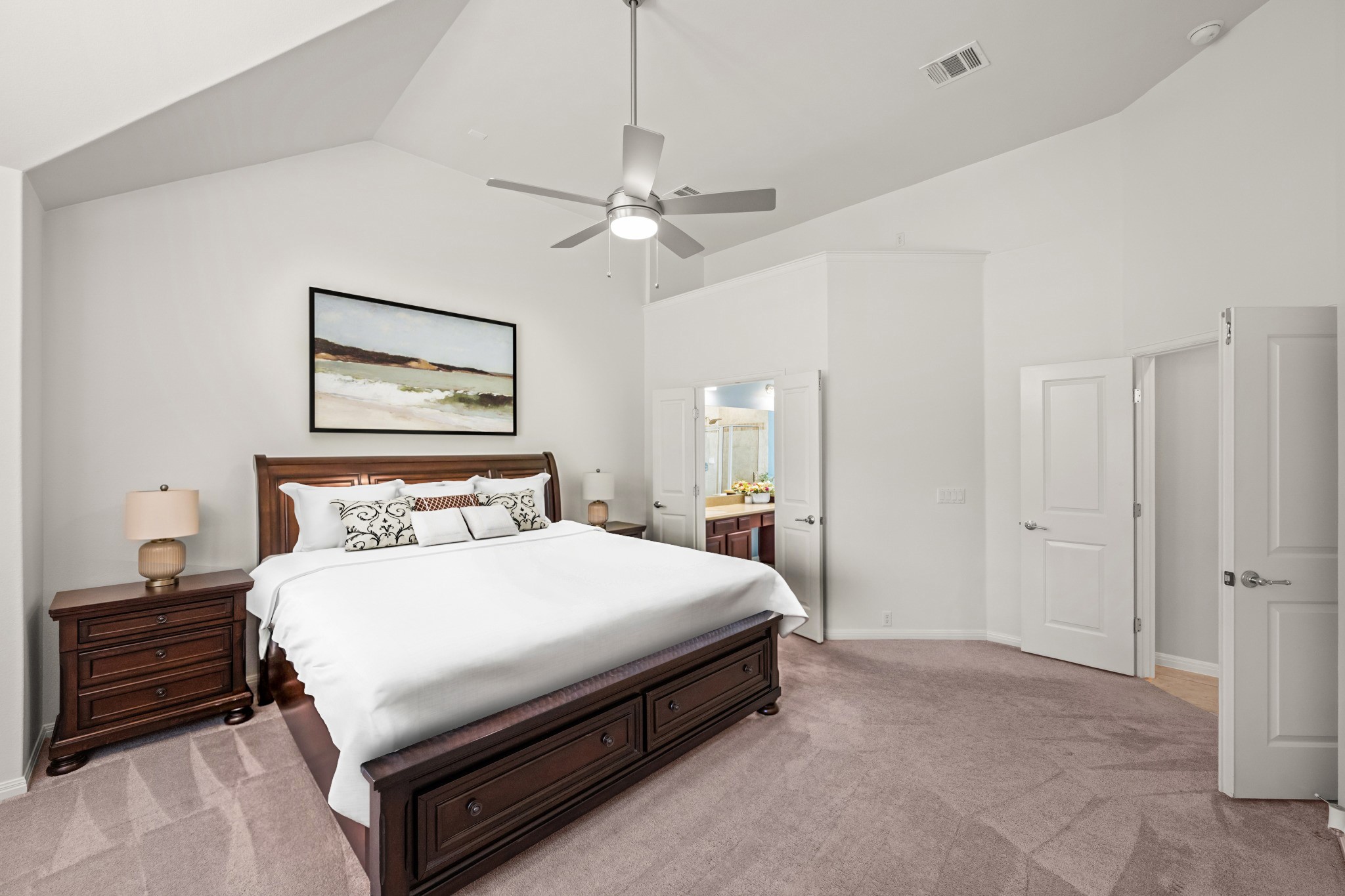 1023 Grassy Field Road Austin, TX 78737 - Photo 17 of 40 Primary bedroom featuring vaulted ceilings, a contemporary ceiling fan, plush carpet flooring, and white paneled french doors.