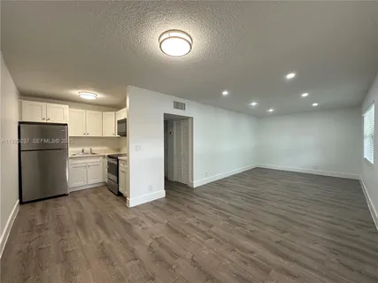 a kitchen with stainless steel appliances a refrigerator and a stove top oven