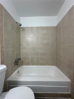 a bathroom with a bathtub and a toilet