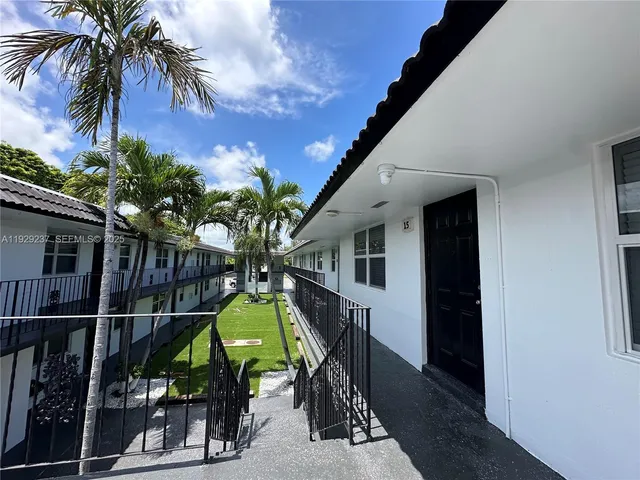 a view of swimming pool with a potted plants and a palm tree
