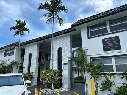 a palm tree sitting in front of a house