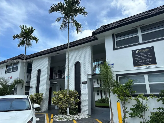 a palm tree sitting in front of a house