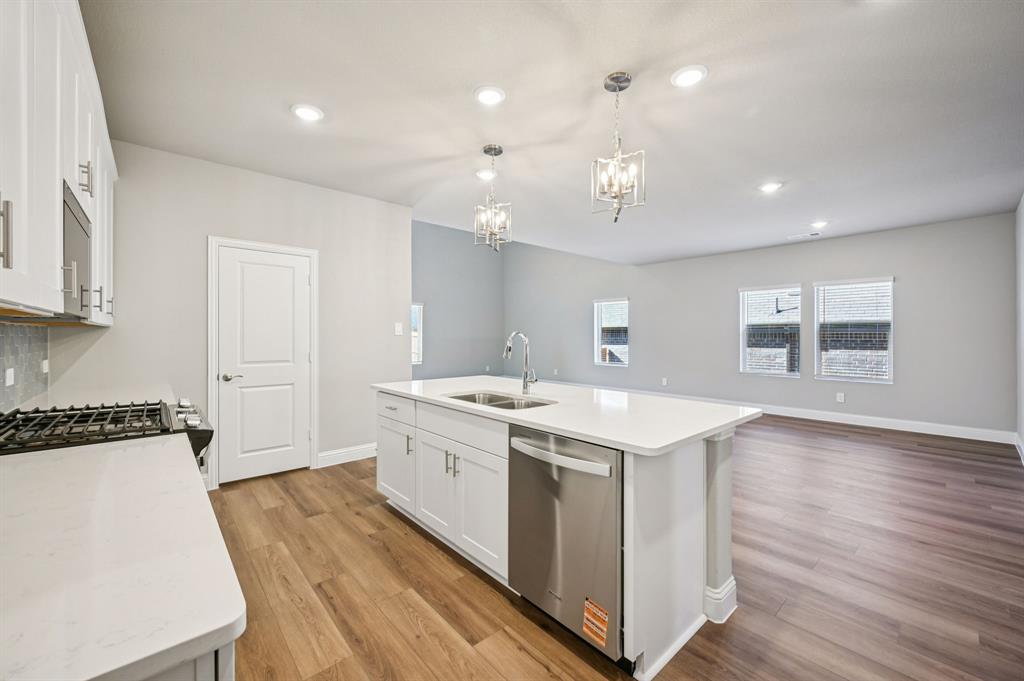 505 Stagg Street McKinney, TX 75069 - Photo 14 of 39 a kitchen with a sink stove and cabinets