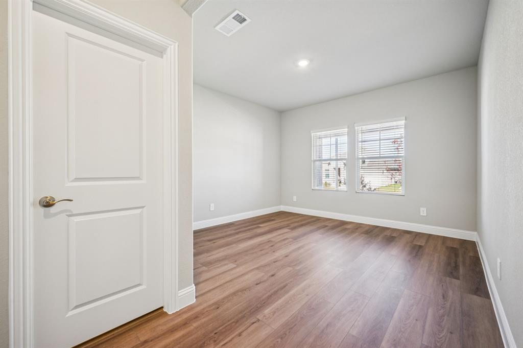 505 Stagg Street McKinney, TX 75069 - Photo 15 of 39 an empty room with wooden floor and windows