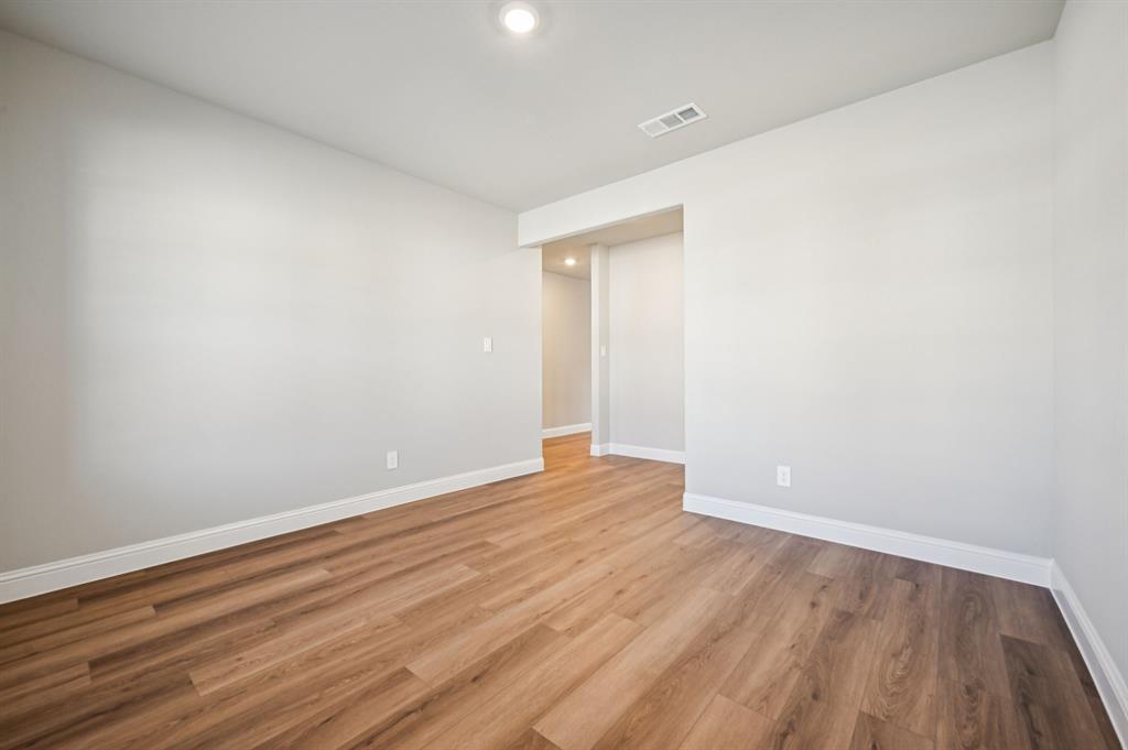 505 Stagg Street McKinney, TX 75069 - Photo 16 of 39 a view of an empty room with wooden floor