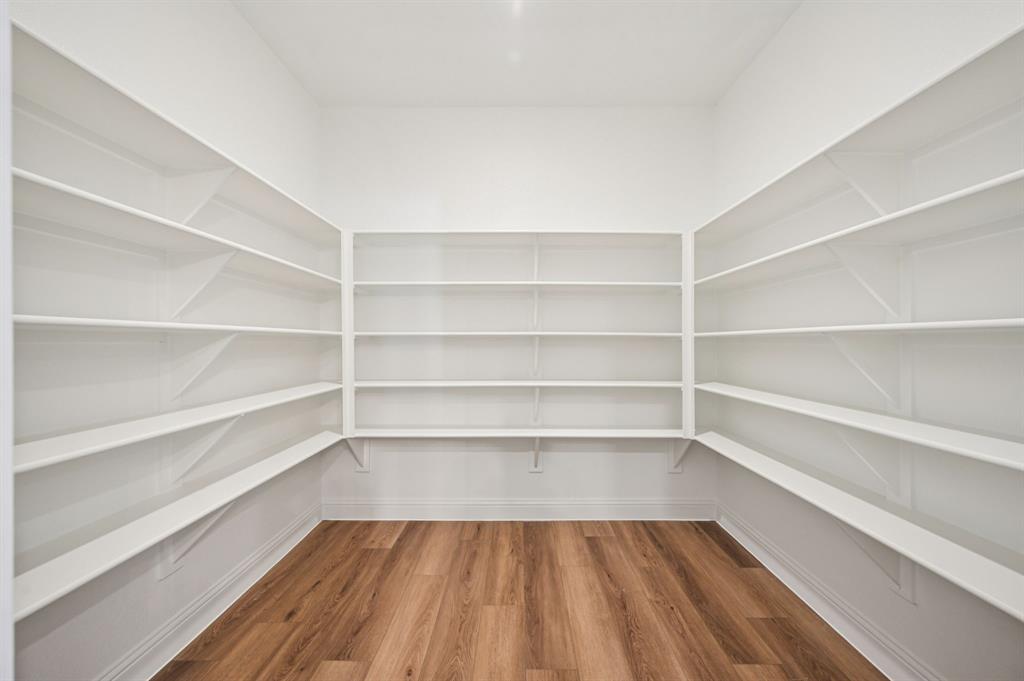 505 Stagg Street McKinney, TX 75069 - Photo 17 of 39 a view of a room with shelf on the wall