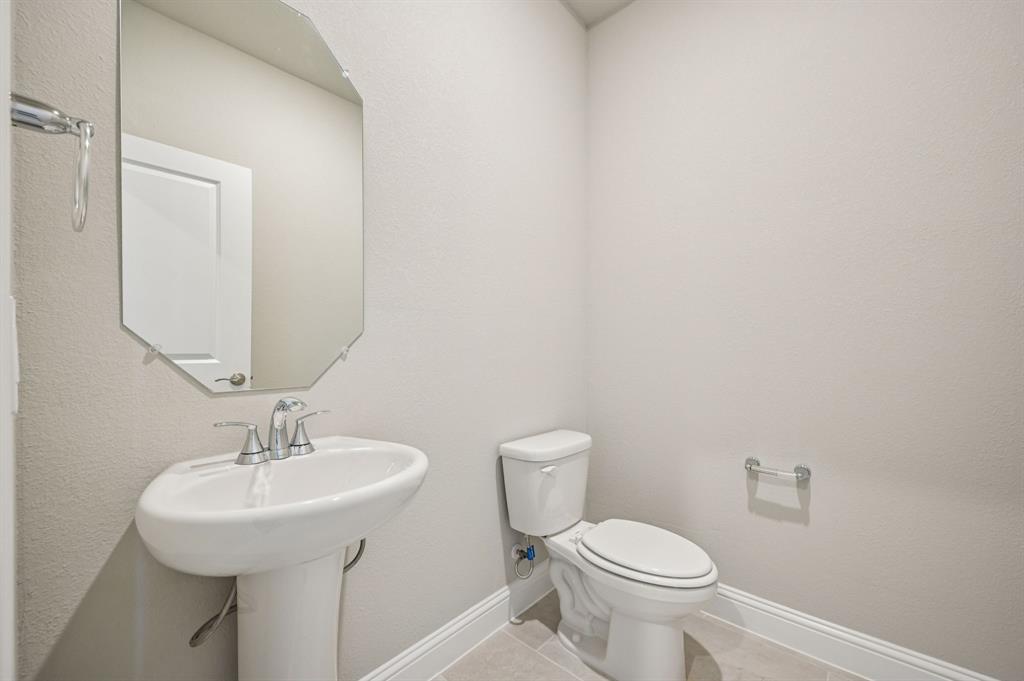 505 Stagg Street McKinney, TX 75069 - Photo 18 of 39 a bathroom with a toilet sink and mirror