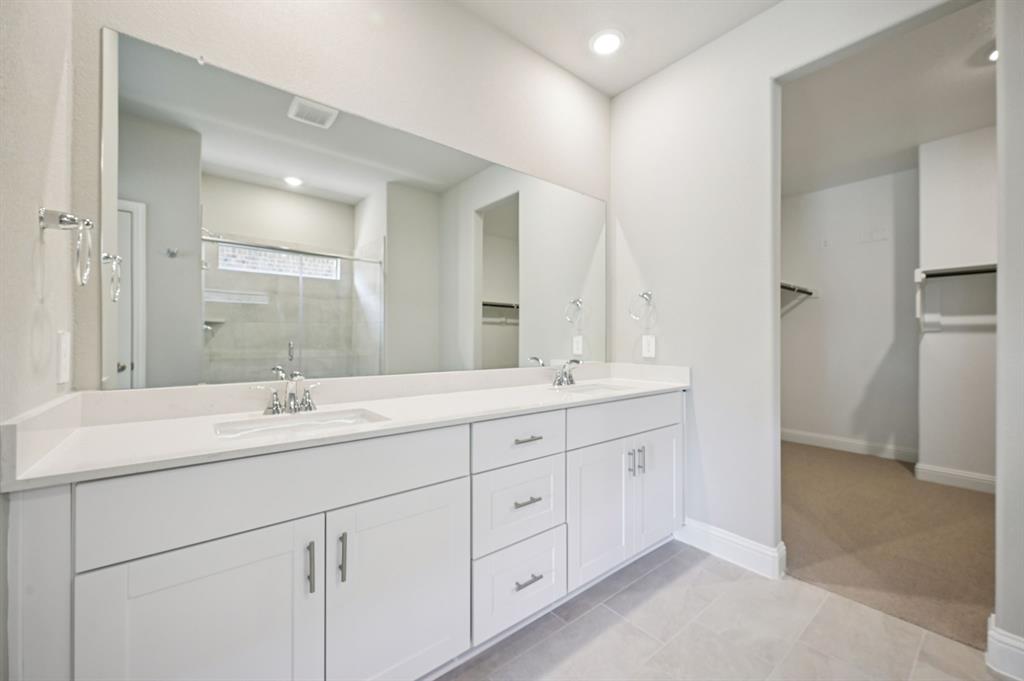 505 Stagg Street McKinney, TX 75069 - Photo 23 of 39 a bathroom with double sink and a mirror