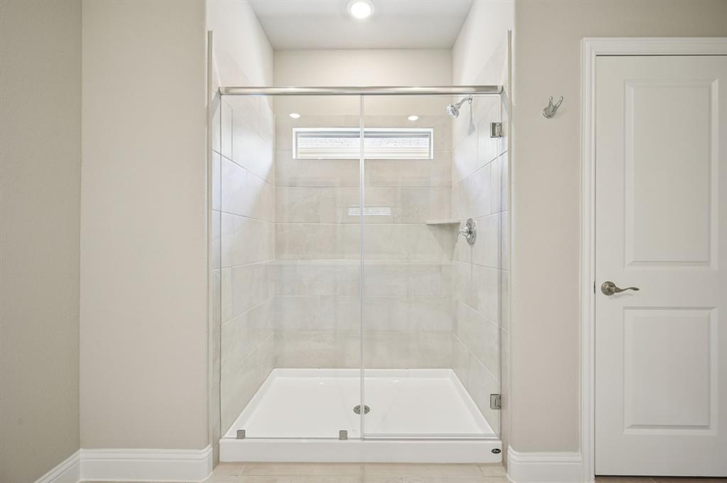 505 Stagg Street McKinney, TX 75069 - Photo 24 of 39 a bathroom with a glass shower door