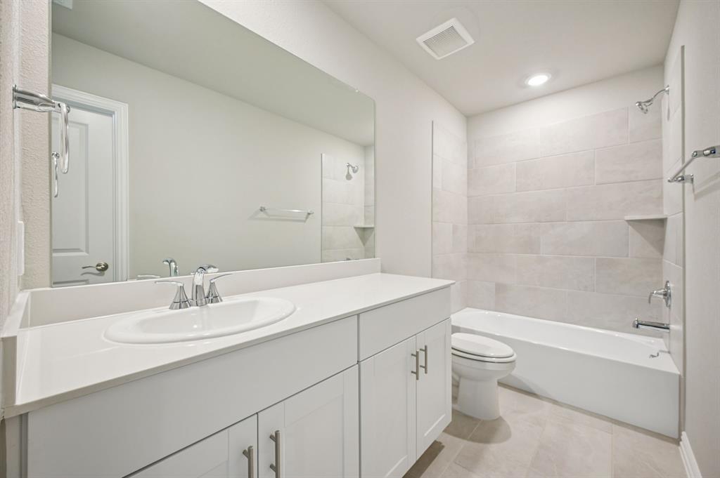 505 Stagg Street McKinney, TX 75069 - Photo 34 of 39 a bathroom with a sink a toilet and shower