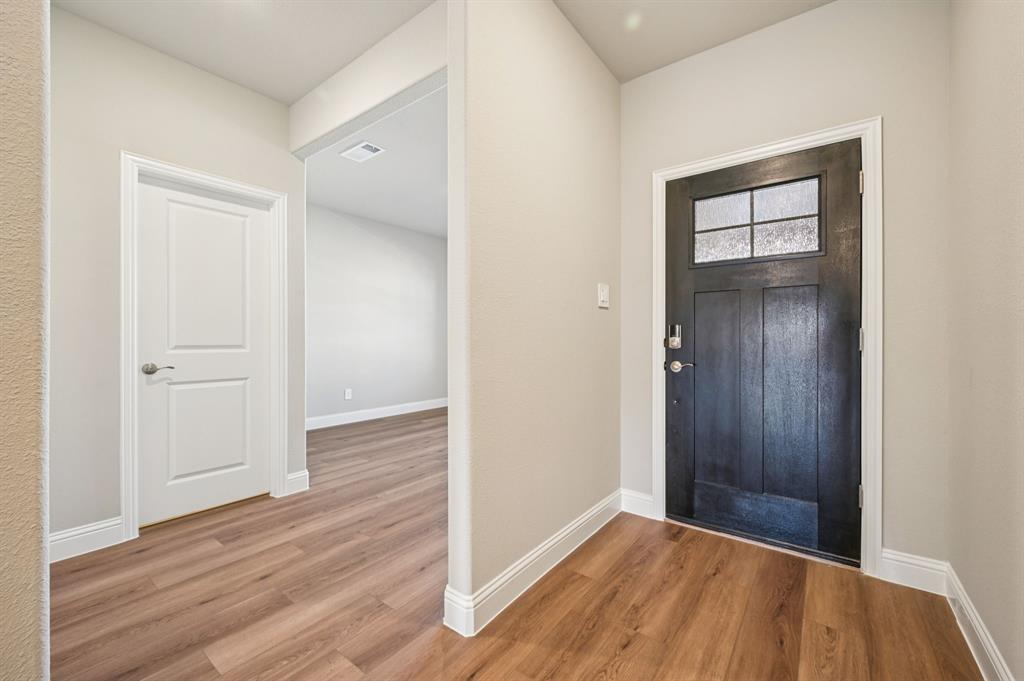 505 Stagg Street McKinney, TX 75069 - Photo 4 of 39 an empty room with wooden floor and closet