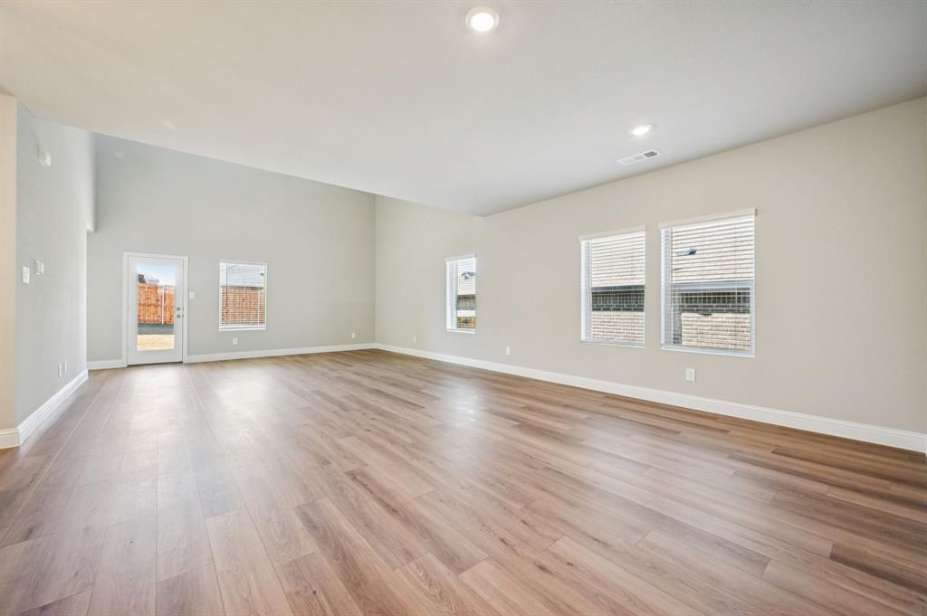 505 Stagg Street McKinney, TX 75069 - Photo 5 of 39 a view of empty room with wooden floor and windows