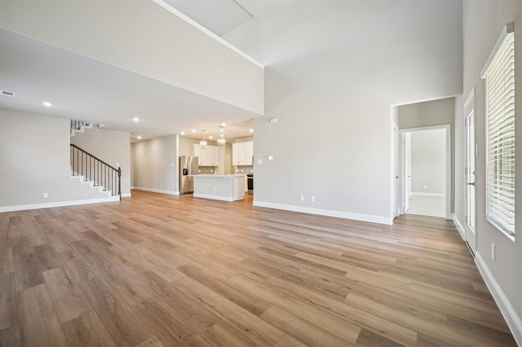 505 Stagg Street McKinney, TX 75069 - Photo 9 of 39 a view of empty room with wooden floor