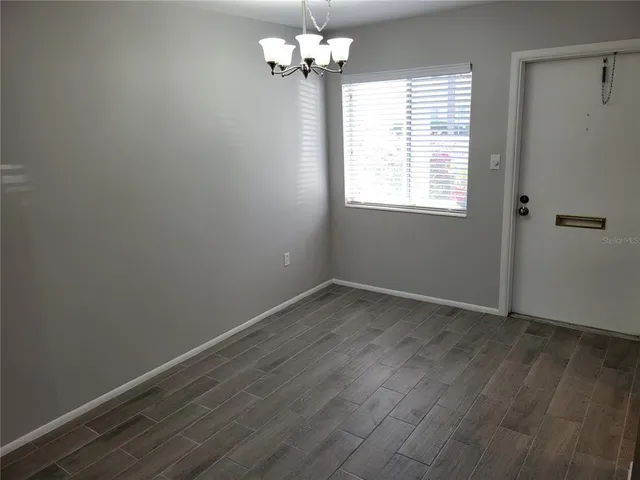 a view of a room with wooden floor and windows