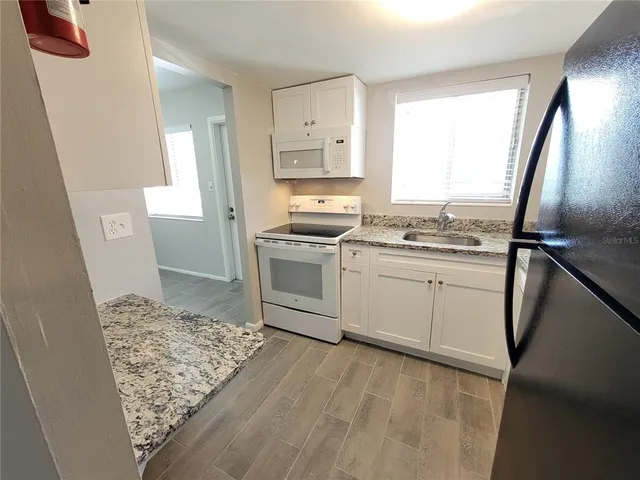 a kitchen with a sink stove and refrigerator
