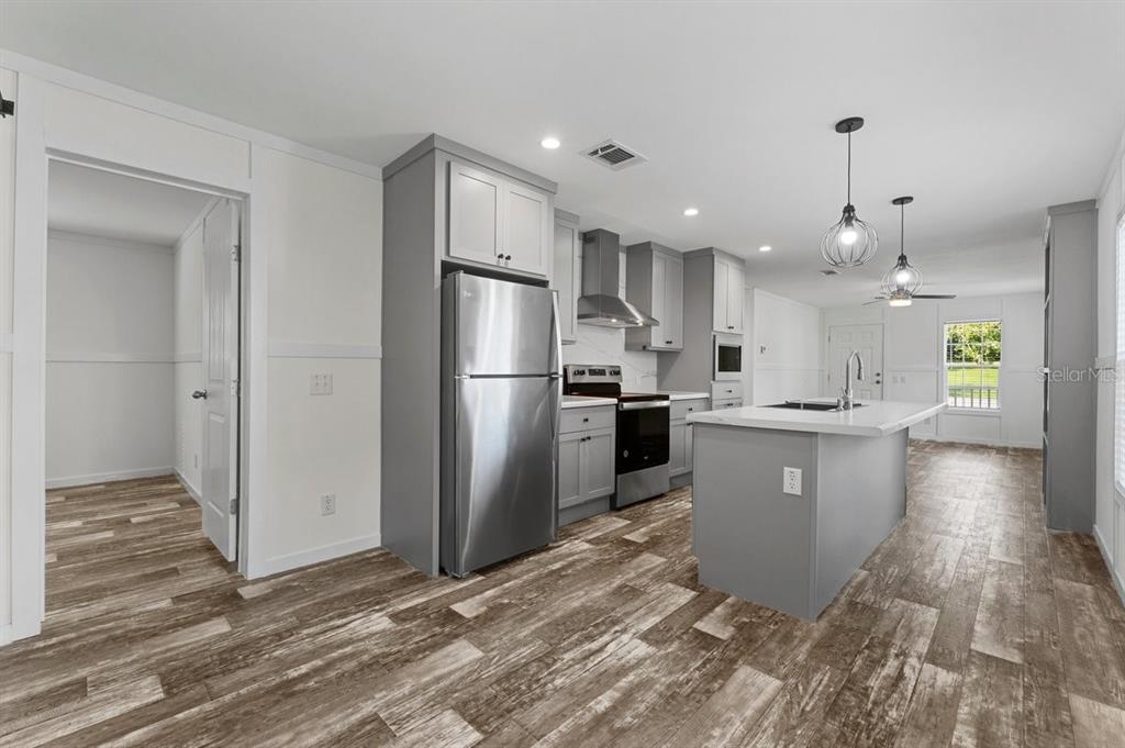 2270 Griffin Road Bartow, FL 33830 - Photo 5 of 33 a kitchen with refrigerator and windows