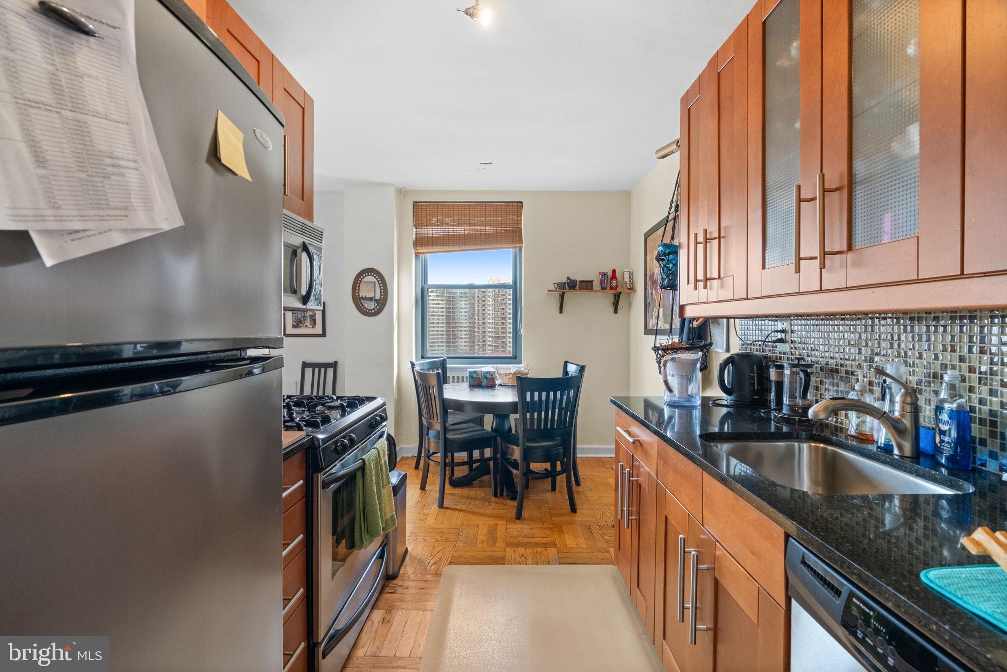 2601 Pennsylvania Avenue, Unit 1132 Philadelphia, PA 19130 - Photo 18 of 28 a kitchen with stainless steel appliances granite countertop a sink a stove and a refrigerator