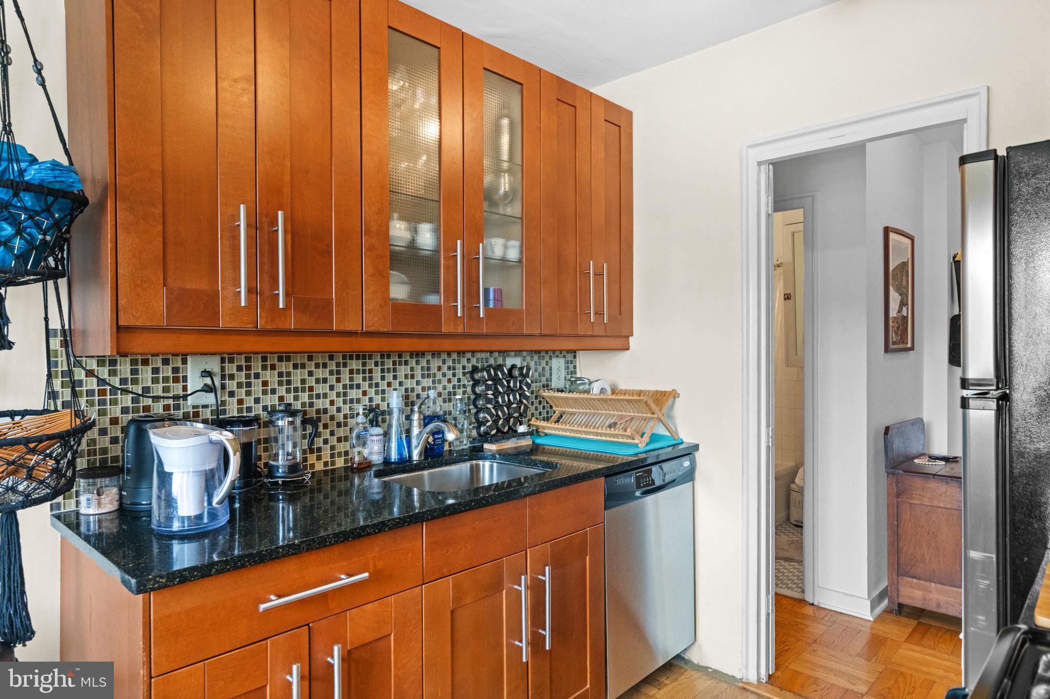 2601 Pennsylvania Avenue, Unit 1132 Philadelphia, PA 19130 - Photo 21 of 28 a kitchen with stainless steel appliances granite countertop a refrigerator and a sink