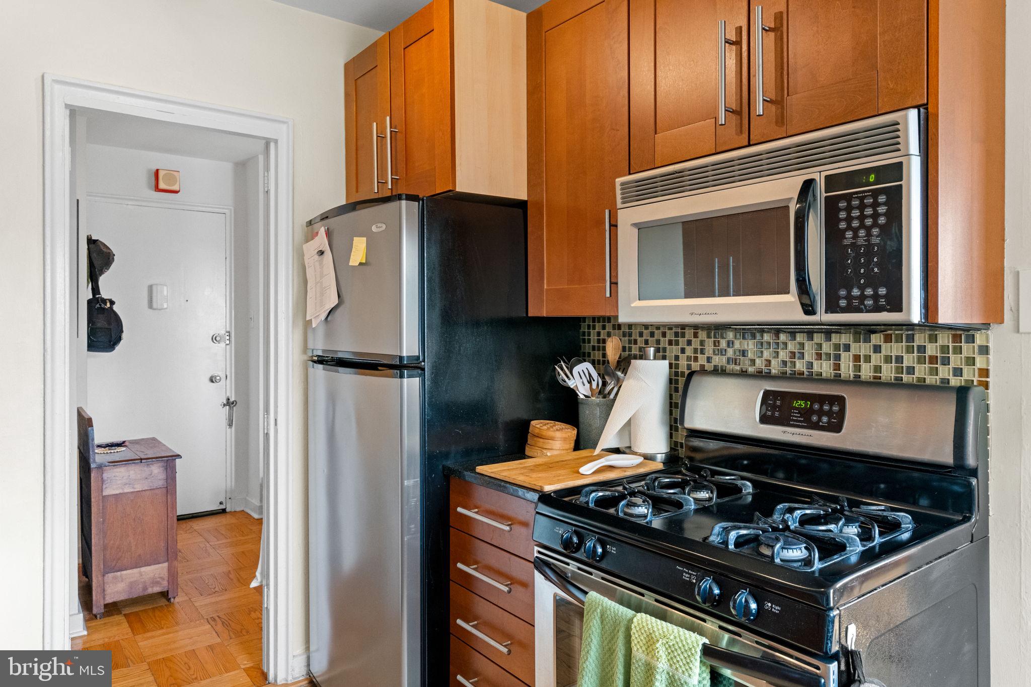 2601 Pennsylvania Avenue, Unit 1132 Philadelphia, PA 19130 - Photo 22 of 28 a kitchen with stainless steel appliances granite countertop a stove and a refrigerator