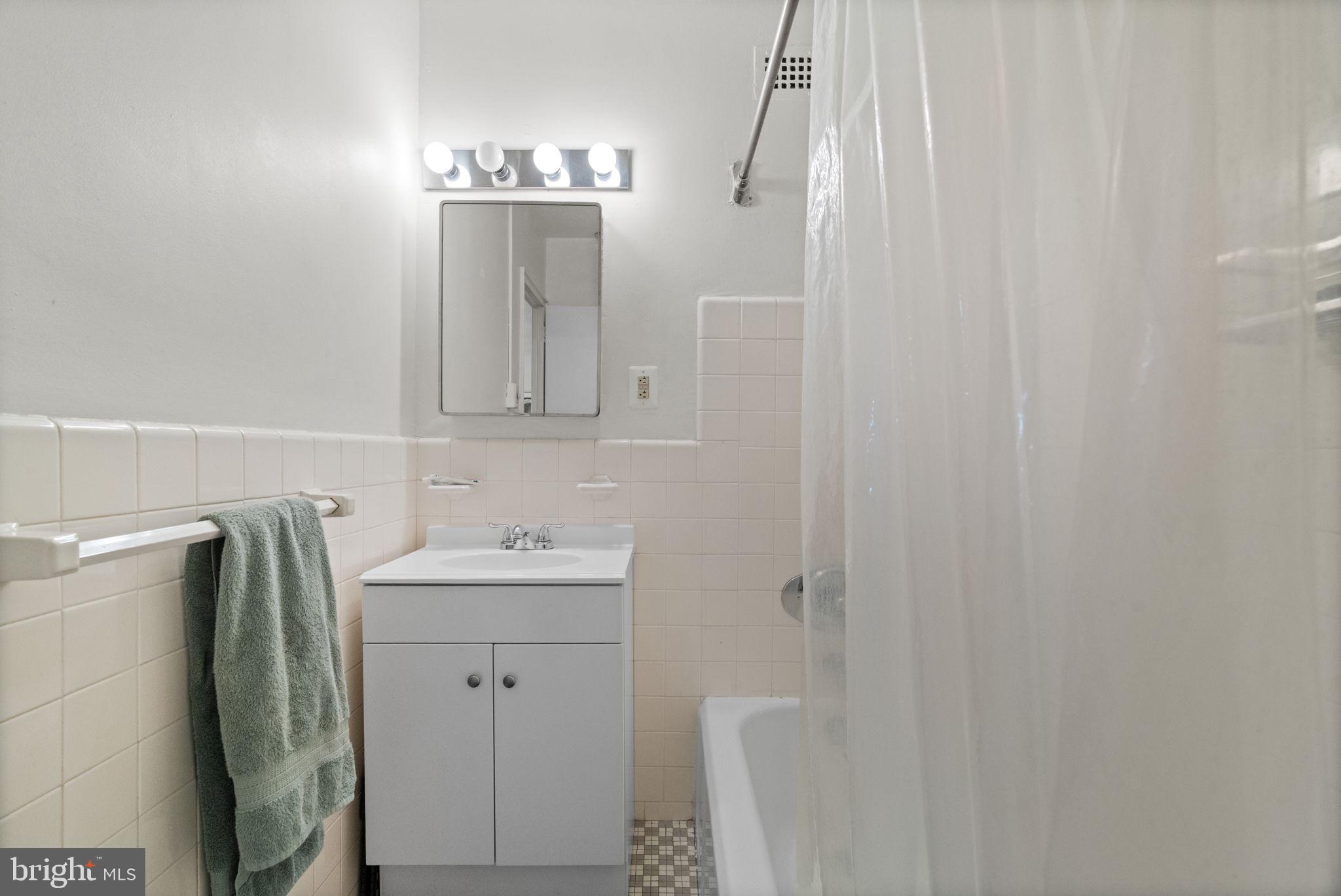 2601 Pennsylvania Avenue, Unit 1132 Philadelphia, PA 19130 - Photo 27 of 28 a bathroom with a sink and mirror