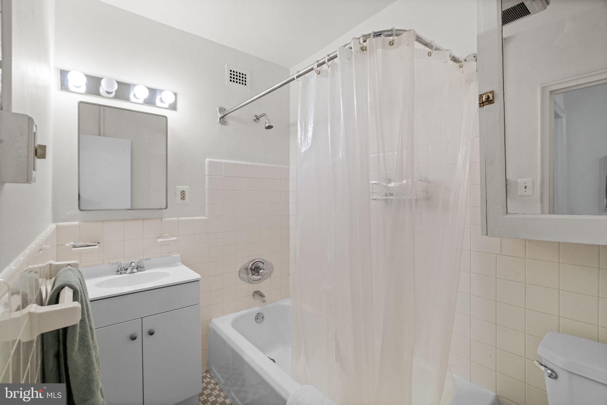 2601 Pennsylvania Avenue, Unit 1132 Philadelphia, PA 19130 - Photo 10 of 28 a bathroom with a sink a toilet and shower