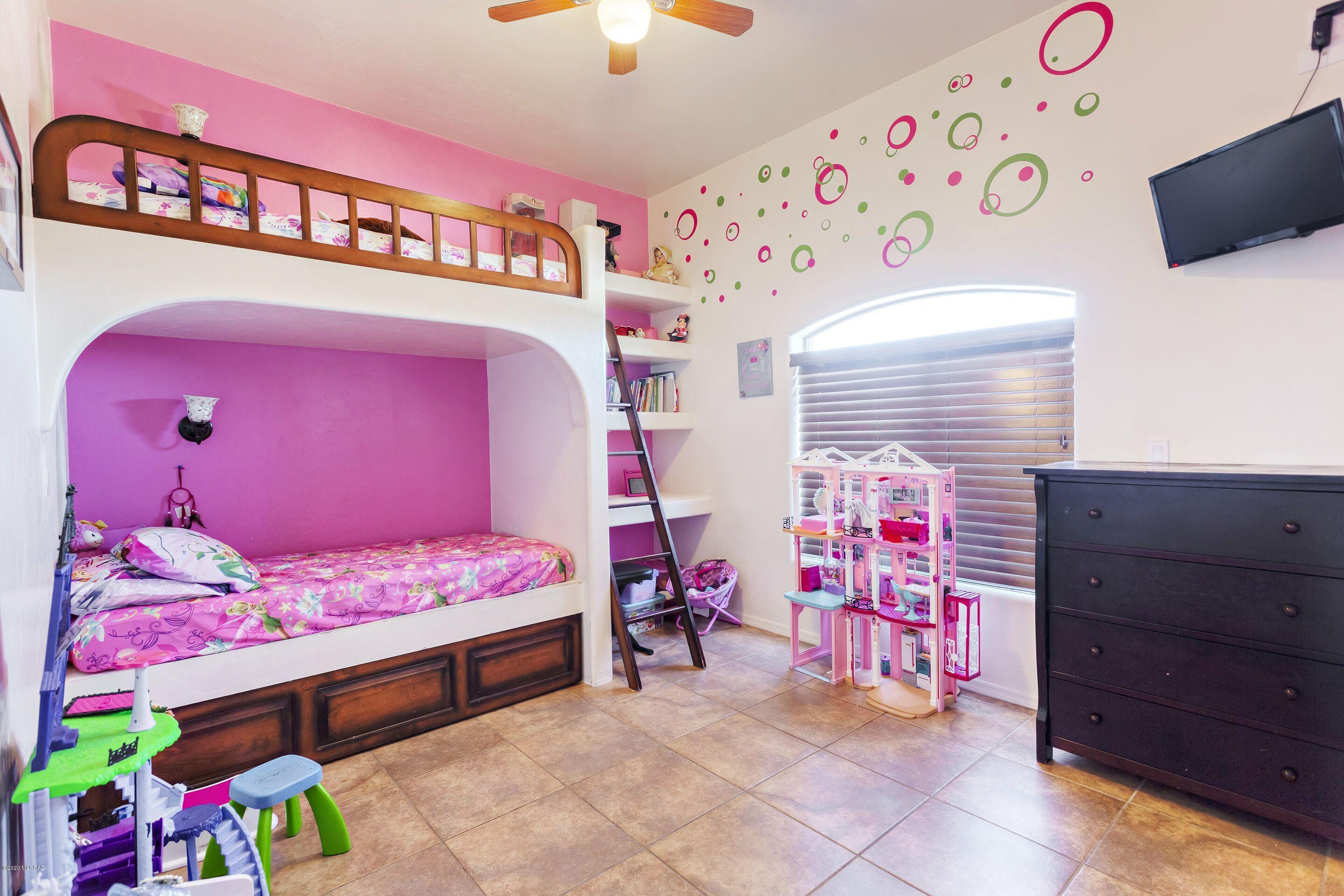 928 Paseo Cieneguita Rio Rico, AZ 85648 - Photo 15 of 27 a bedroom with a bed and a window