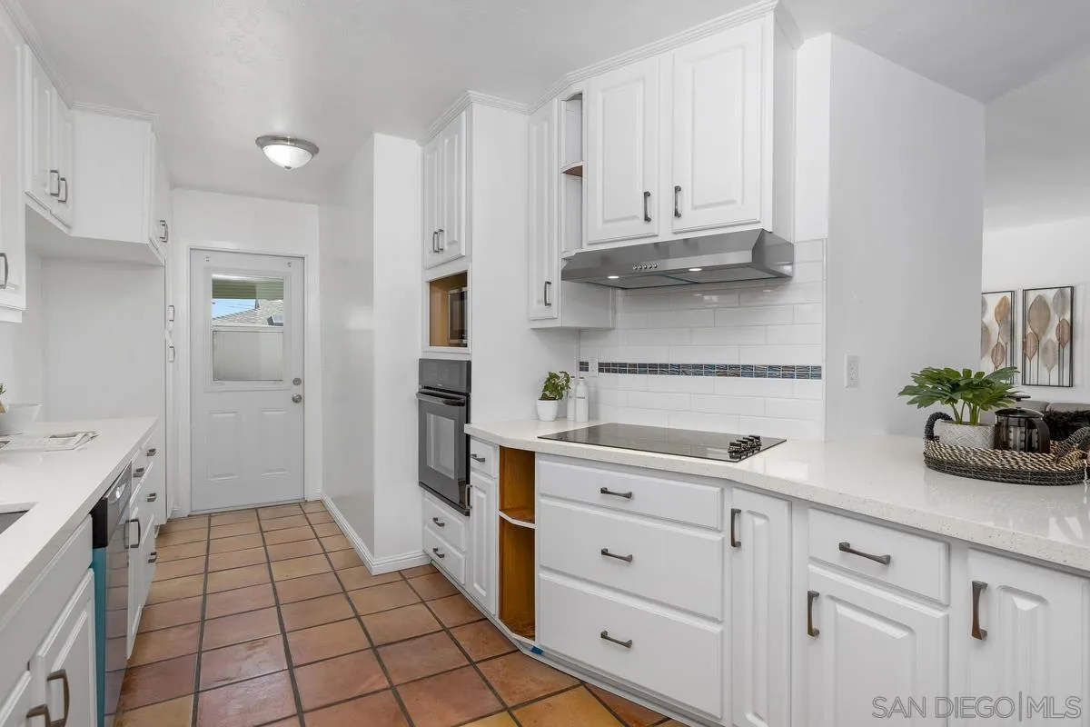 2567 Pheasant Drive San Diego, CA 92123 - Photo 13 of 31 a kitchen with white cabinets and appliances