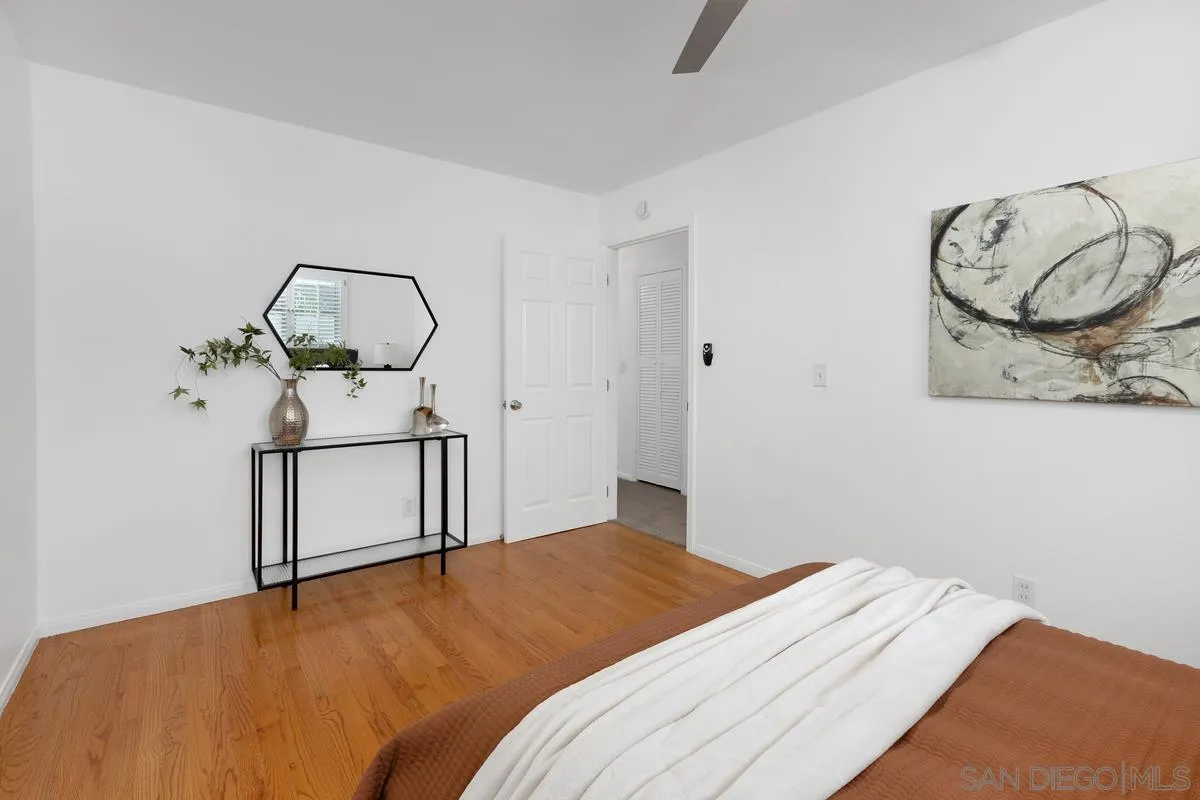 2567 Pheasant Drive San Diego, CA 92123 - Photo 16 of 31 a bedroom with a bed and chandelier