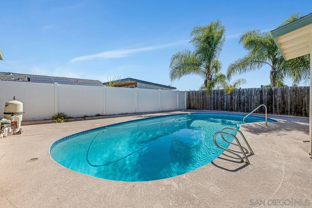 2567 Pheasant Drive San Diego, CA 92123 - Photo 26 of 31 a view of a swimming pool with a yard and palm trees