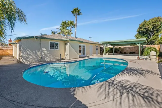 a view of a swimming pool with a yard