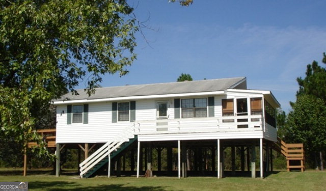 1532 Dyal School Road Baxley, GA 31513 - Photo 1 of 1 a front view of a house with a garden