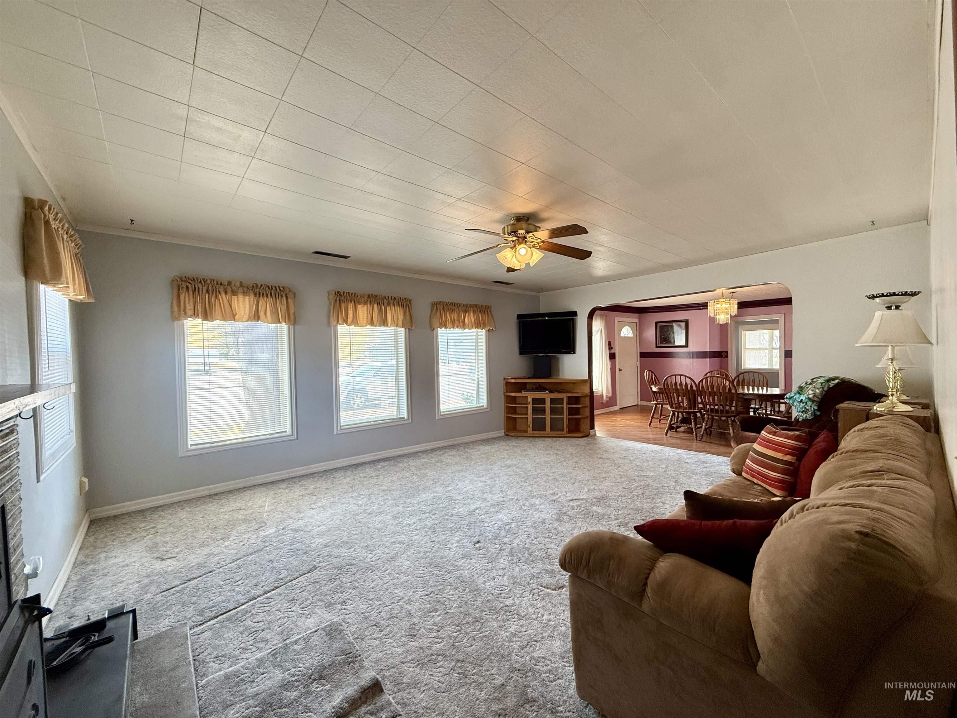 2395 Villard Street Pomeroy, WA 99347 - Photo 11 of 50 Carpeted living area featuring arched walkways and ceiling fan