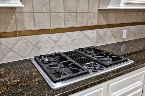 a kitchen with a sink and stainless steel appliances