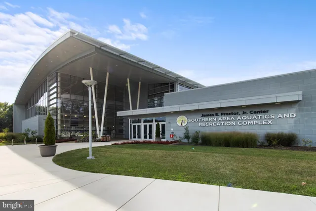 a man walking down a street next to a building