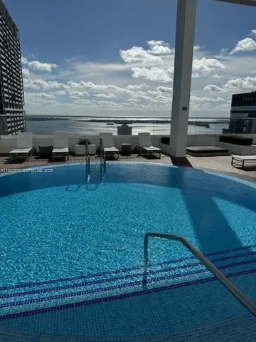 a view of swimming pool with furniture