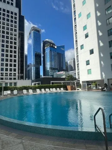 a view of a swimming pool and outdoor seating