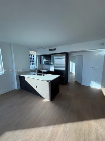 a kitchen with a sink and a stove top oven