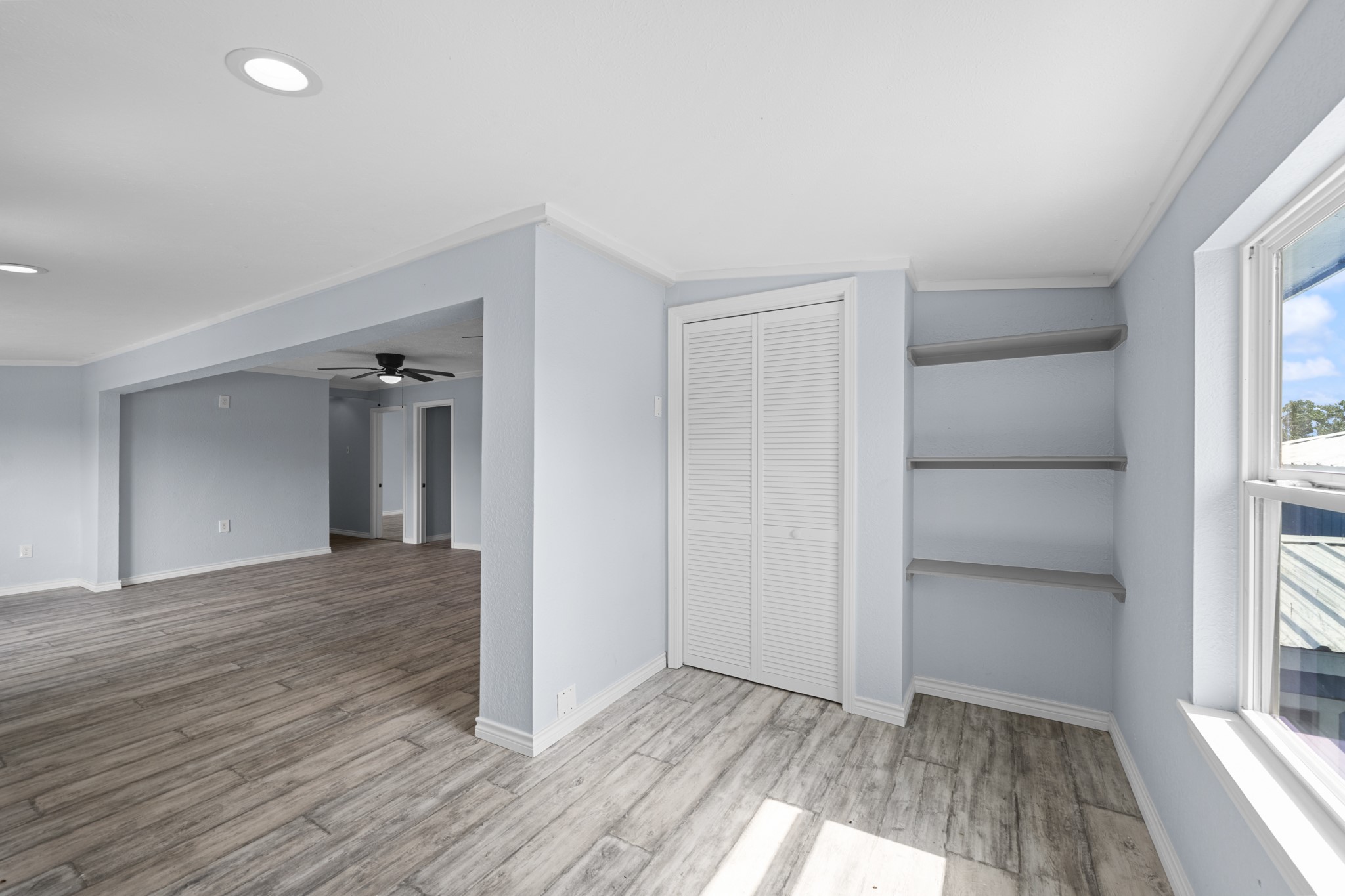 2534 Bastrop Angleton, TX 77515 - Photo 50 of 50 Versatile bonus area featuring abundant natural light, built-in shelving, and continued wood-look flooring for a cohesive modern feel. Ideal for a reading nook, hobby space, or additional seating area within the open floor plan.