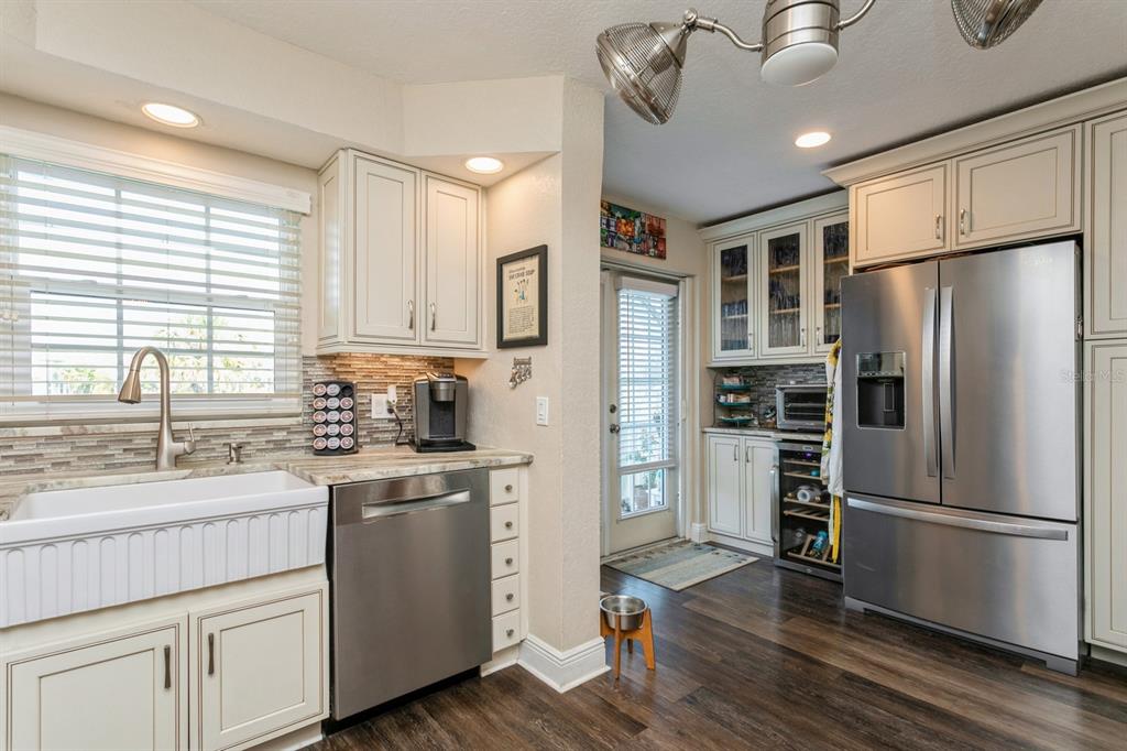 9166 Blind Pass Road St. Pete Beach, FL 33706 - Photo 11 of 37 a kitchen with a refrigerator stove and sink