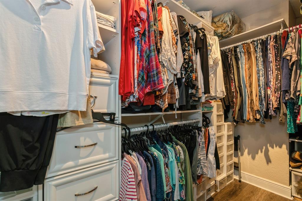 9166 Blind Pass Road St. Pete Beach, FL 33706 - Photo 18 of 37 a view of walk in closet with clothes