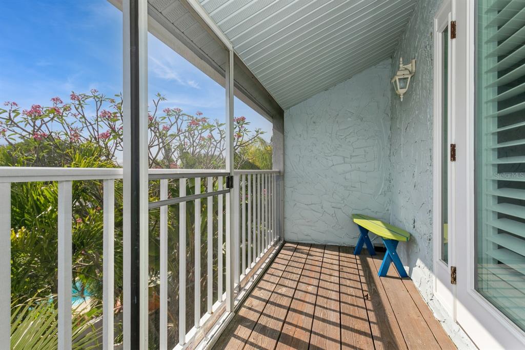 9166 Blind Pass Road St. Pete Beach, FL 33706 - Photo 21 of 37 a view of a balcony with a couple of flower plants