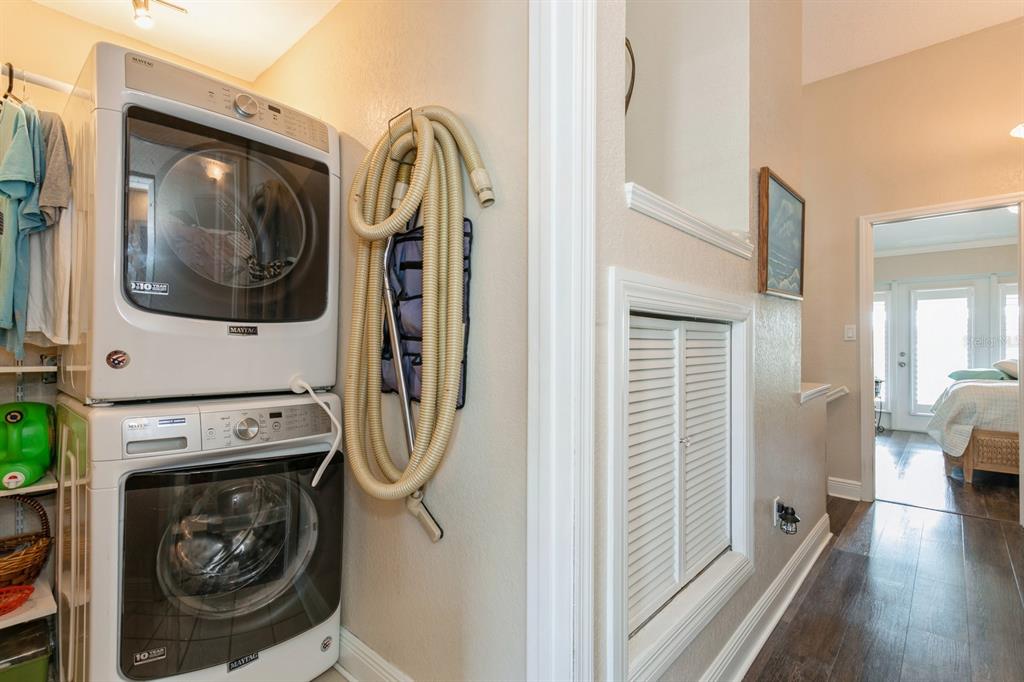 9166 Blind Pass Road St. Pete Beach, FL 33706 - Photo 22 of 37 a utility room with wooden floor washer and dryer