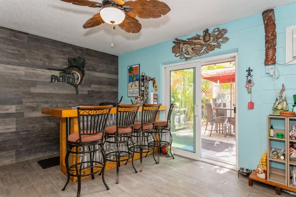 9166 Blind Pass Road St. Pete Beach, FL 33706 - Photo 30 of 37 a view of a chairs and tables in the room