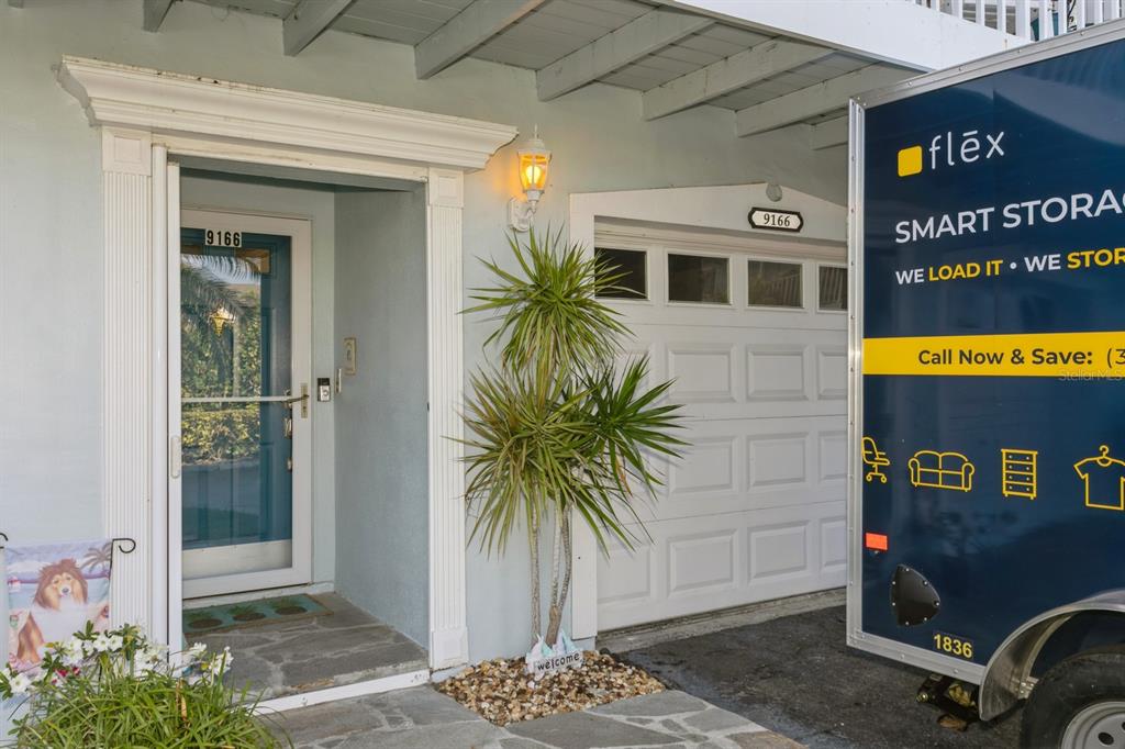 9166 Blind Pass Road St. Pete Beach, FL 33706 - Photo 3 of 37 a view of a entryway door of the house
